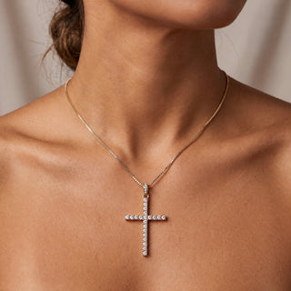14K yellow gold natural diamond cross pendant worn on model
