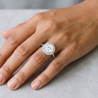1 ct Round Double Halo Moissanite Ring in sterling silver, worn on hand