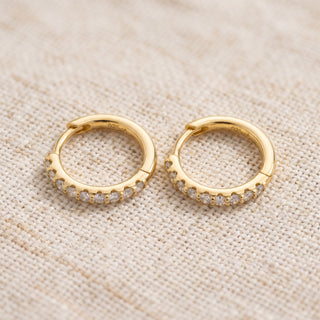 Slim shared prong moissanite huggie hoop earrings, macro detail of the hinged snap closure