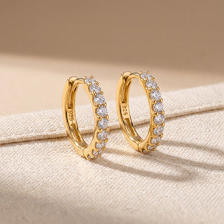 Slim shared prong moissanite huggie hoop earrings, angled view