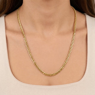 Superior Silver 14kt yellow gold over 925 sterling silver 4.7mm Miami Cuban link chain worn around a model's neck.
