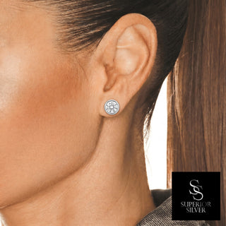 5mm round bezel solitaire moissanite stud earrings in sterling silver, worn on model