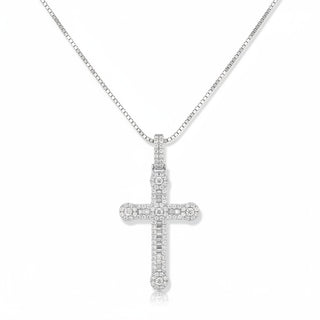 A silver cross pendant necklace paved with small clear stones, hanging from a silver box chain against a plain white background.