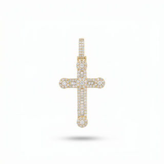 A gold cross pendant paved with small clear gemstones, centered on a plain white background with a soft shadow underneath.