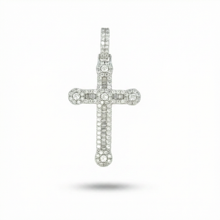 A silver-toned cross pendant encrusted with small clear gemstones, shown centered against a plain white background with a soft shadow underneath.