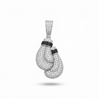 A silver-toned pendant shaped like a pair of boxing gloves, heavily embellished with small clear stones and accented with black stones, shown on a plain white background.