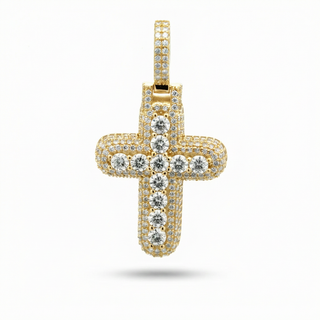A gold cross pendant encrusted with clear cubic zirconia stones, presented on a clean white background with a soft shadow underneath.
