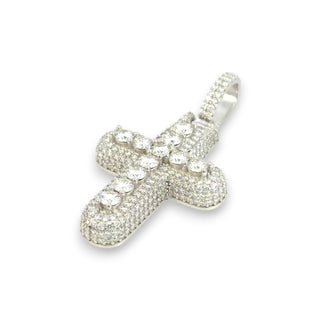 A silver cross pendant encrusted with clear cubic zirconia stones, set against a plain white background.