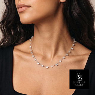Alternating Round Stone Line Moissanite Necklace in sterling silver, worn on model