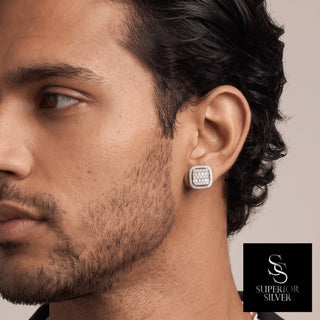 Baguette center cushion halo moissanite stud earrings in sterling silver, worn on model