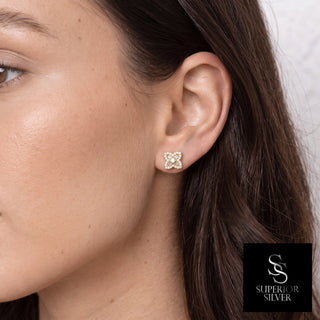 Model wearing gold vermeil baguette flower moissanite stud earrings