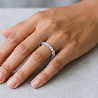 Bar-Set Round Eternity Band Moissanite Ring in sterling silver, worn on hand
