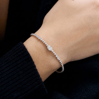 Beaded Round Bezel Station Moissanite Bangle in Sterling Silver worn on the wrist