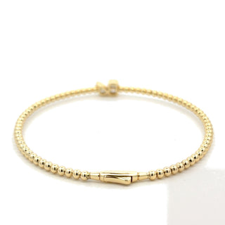 Beaded two-stone station moissanite bangle in yellow gold vermeil over sterling silver