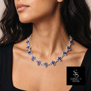 Clover and Infinity Link Moissanite Necklace in sterling silver, blue stones, worn on model