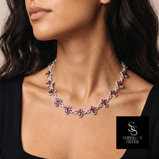 Clover and Infinity Link Moissanite Necklace in sterling silver, red stones, worn on model