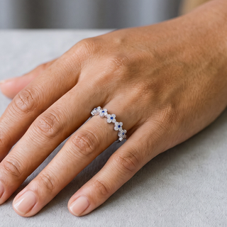 Clover Band with Blue Accent Stones Moissanite Ring in sterling silver, worn on hand