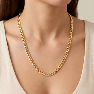 Superior Silver 18-inch curb link chain in solid 10K yellow gold with a 5.4mm width and polished finish on a model.