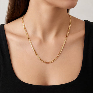 Superior Silver 10K yellow gold 3.0mm curb link chain necklace worn on a model against a black top