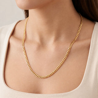 Superior Silver 24-inch curb link chain in 14kt yellow gold over 925 sterling silver worn around a woman's neck.