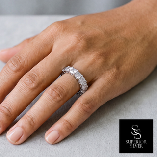Cushion-Cut Prong-Set Eternity Band Moissanite Ring in sterling silver, worn on hand