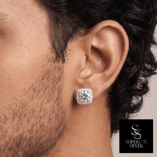 Cushion halo round moissanite stud earrings in sterling silver, worn on model