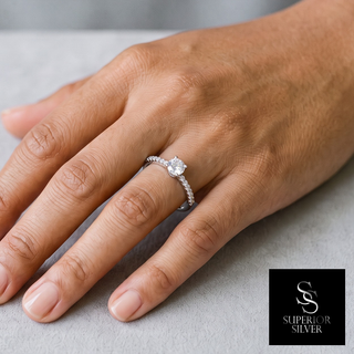 Dainty Round Solitaire with Prong-Set Accent Band Moissanite Ring in sterling silver, worn on hand