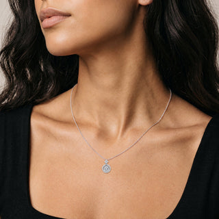 Dancing Stone Round Halo Moissanite Necklace in sterling silver, worn on model