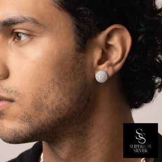 Domed round pavé moissanite stud earrings in sterling silver, worn on model