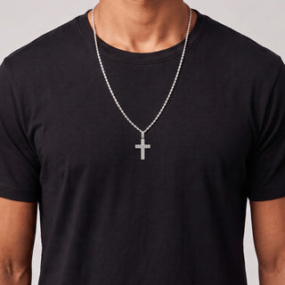 Double-Border Pavé Cross with Prong-Set Center Row Moissanite Pendant in sterling silver, worn on model