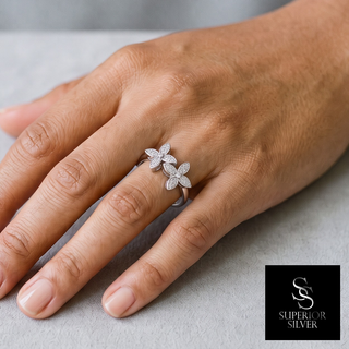 Double Five-Petal Flower Bypass Moissanite Ring in sterling silver, worn on hand