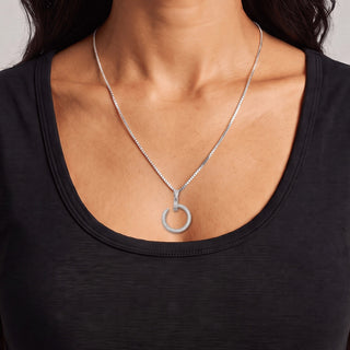 Double-Row Pavé Open Circle Drop Moissanite Pendant in sterling silver, worn on model
