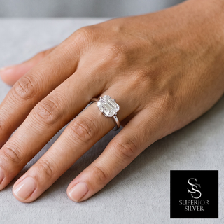 East-West Emerald-Cut Solitaire Moissanite Ring in sterling silver, worn on hand