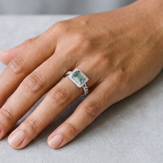 East-West Green Emerald-Cut Halo on Curb Chain Band Moissanite Ring in sterling silver, worn on hand
