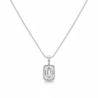 A silver necklace with a rectangular emerald-cut clear gemstone pendant, displayed on a clean white background.