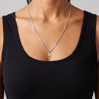 Emerald-Cut Bezel-Set Solitaire Moissanite Pendant in sterling silver, worn on model