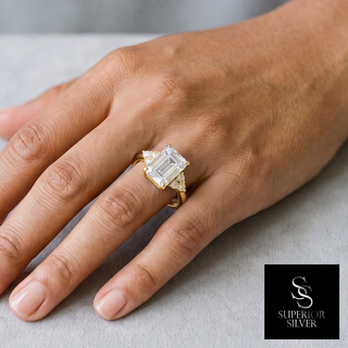 Emerald-Cut with Round Cluster Sides Moissanite Ring in yellow gold vermeil over sterling silver, worn on hand
