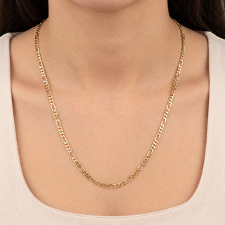 Superior Silver 10K yellow gold 3.2mm Figaro link chain worn around a model's neck, featuring a polished finish.