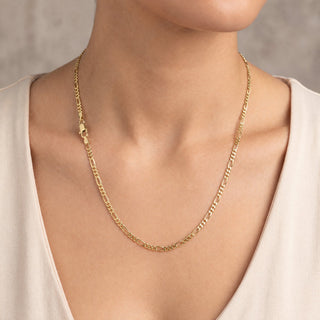 Superior Silver 20-inch 10K yellow gold figaro link chain with a lobster clasp worn around a model's neck