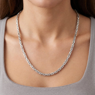 Superior Silver 24-inch flat Byzantine link chain in polished rhodium over 925 sterling silver worn around the neck.