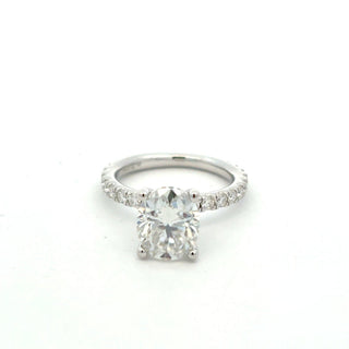 Four-Prong oval solitaire on pavé band moissanite ring in sterling silver