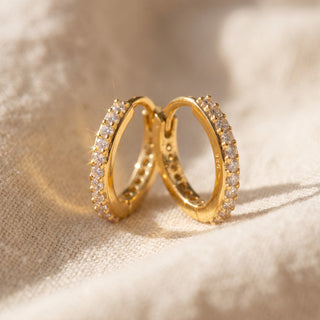 Close-up of the gold vermeil slim pave huggie showing the plain polished back arc
