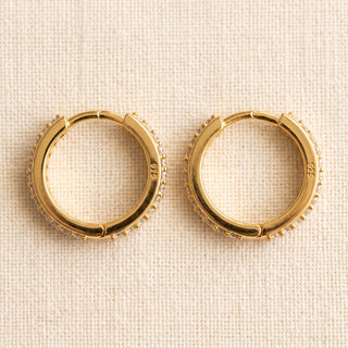 Detail of the hinged snap closure on the gold vermeil slim pave huggie hoop