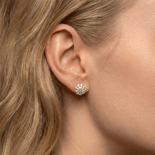 Gold vermeil round flower halo moissanite stud earrings shown on model