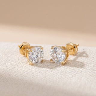 Gold vermeil 8mm round moissanite solitaire stud earrings, macro detail of the four-prong basket