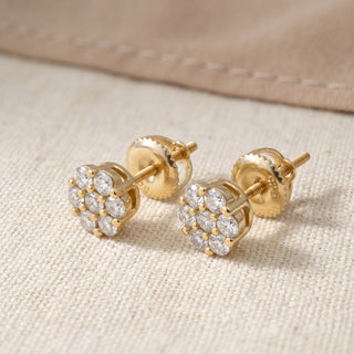 Gold vermeil seven stone daisy cluster moissanite stud earrings, macro detail of the shared prong setting