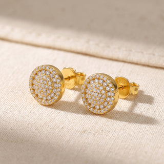 Close-up of the gold vermeil pavé disc stud showing the concentric rings on a flat face