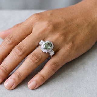 Green Oval Baguette Halo with Round Side Stones Moissanite Ring in sterling silver, worn on hand
