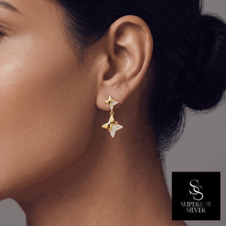 Half pavé four-point star drop moissanite earrings in yellow gold vermeil over sterling silver, worn on model