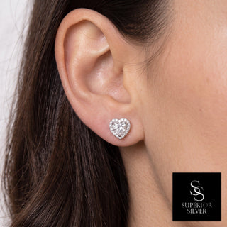 Sterling silver heart shaped halo moissanite stud earrings shown on model